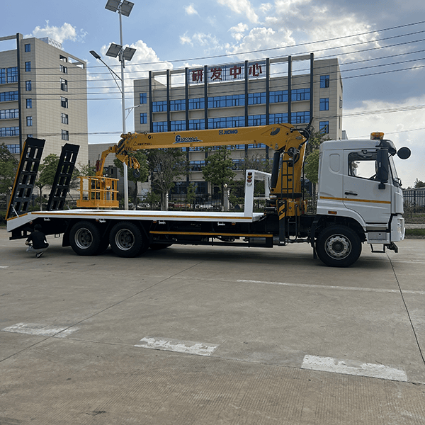Multi-functional flatbed transport truck with a mobile crane
