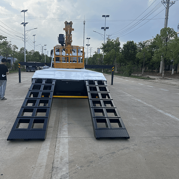 Multi-functional flatbed transport truck with a mobile crane